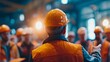 © AS Studio - Diverse construction workers in safety vests and hard hats at industrial site with warm lighting