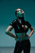 © Bliss - Seductive young woman poses confidently in stylish black latex outfit in studio