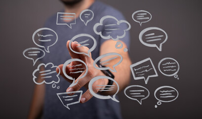 Person interacting with a digital interface featuring speech bubbles, conveying communication, connectivity, and modern technology concepts in t