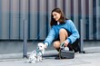 © nazariykarkhut - Young woman petting her dog in the city