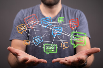Conceptual image representing communication, connection, and networking with glowing message bubbles held in hands.