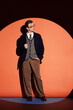 © LIGHTFIELD STUDIOS - Stylish teenager dressed sharply against a vibrant backdrop showcasing youth culture