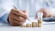 © liliyabatyrova - Dentist organizes financial records while focusing on dental practice growth with a tooth model and coins
