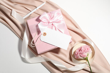 Wall Mural - Blank card, gift box, pen, ribbon, cloth and beautiful rose on white background, top view