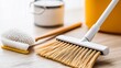 © Tara - Cleaning Tools Still Life: Broom, Brush, Bucket, and Dustpan on Wooden Surface