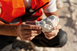© Maria Vitkovska - Geologist or miner examining white rocks in open quarry