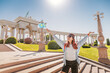 © EdNurg - Young woman tourist holding a small Kazakhstan flag in Almaty