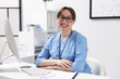 © New Africa - Professional nurse working at desk in office