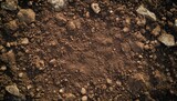 Close-up view of dark brown soil with small rocks