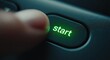 © Rafly - A close-up view of a finger pressing a button with the word 'start' illuminated in green