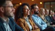 © Vadym - Diverse group of smiling people sit in audience watching presentation. Professionals listen attentively during seminar, engaged in learning. Colleagues share experience at meeting event.