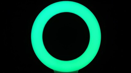 Wall Mural - A luminous energy ring cycles through a spectrum of colors, displaying a mesmerizing light transition in timelapse abstract, future, wave