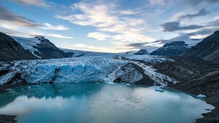 Wall Mural - A vast glacial lake forms and expands as meltwater flows down the icy slopes under a changing sky timelapse ice, environmental impact, glacial lake