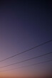 © Luis Garcia - Power lines silhouette during dusk hours, small plane in the background.