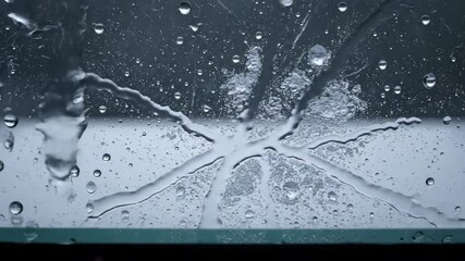 Wall Mural - Mesmerizing time lapse of individual hailstones forming intricate patterns on a clear glass surface during a storm macrophotography, liquid, atmospheric