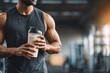 © Ajay - Fit man drinking protein shake from shaker bottle at gym, post workout recovery and sports nutrition.
