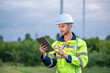 © BESTIMAGE - Male man engineer inspection by tablet gesture check control wind power machine out door wind energy factory. technician professional worker check wind power machine turbine field inspection