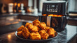 © tu - Crispy golden-brown fried chicken pieces with crunchy texture cooking in modern air fryer on marble kitchen countertop, delicious homemade comfort food prepared quickly for family meals or snacks.