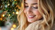 © Luminostock 54 - blonde woman Christmas theme concept. Smiling woman with long hair among greenery and warm lights.