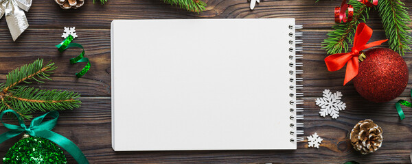 Wall Mural - Christmas blank greeting card mock-up scene. Creative layout made of Christmas tree branches and paper card note. Flat lay. Nature New Year concept