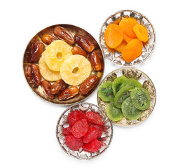 Wall Mural - Plates and bowl with different candied fruits on white background