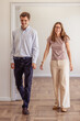 © mariamontoyart - Happy young couple walking into empty apartment new home