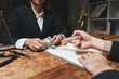 © crizzystudio - Lawyer receiving money for contract agreement
