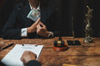 © crizzystudio - Person accepting bribe in legal contract negotiation