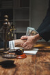 © crizzystudio - Hand passing money during corrupt legal deal