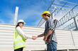 © crizzystudio - Engineers or architects shaking hands at construction site