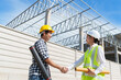 © crizzystudio - Engineers shaking hands confirming construction project agreement