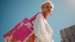 © fotofabrika - Fashionable woman carrying a vibrant tote bag against a clear blue sky in an urban setting