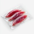 © Edy - Three frozen fish fillets in a clear plastic bag