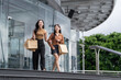 © crizzystudio - Two young asian women carrying shopping bags