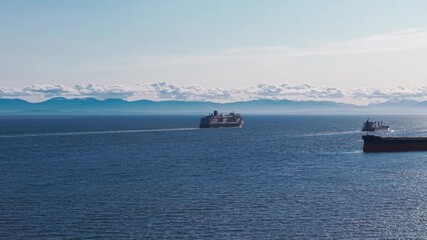 Wall Mural - A scenic shot of a cruise ship sailing on the beautiful seas of west vancouver under a clear blue summer sky.