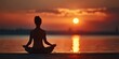 © Anatoll Paveel - A woman meditates, relaxing in a yoga pose at sunset. Silhouette in the lotus position. Back view.