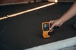 © standret - Close up view of man's hand that is using leveling tool on the floor, construction site