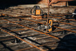 © standret - On metal rods. Close up view of man's hand that is using leveling tool on the floor, construction site