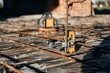 © standret - On metal rods. Close up view of man's hand that is using leveling tool on the floor, construction site