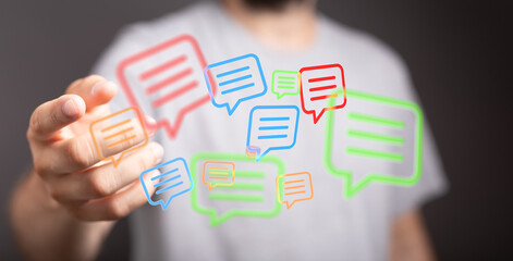 Person reaching for digital speech bubbles, showing online communication and messaging, connecting through social media network.