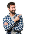© creative png  - Man in plaid shirt points to the side with a smile isolated on white background