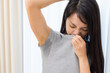 © leungchopan - Young woman suffering from body odor and sweat under arm