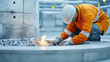 © Somporn Na Ubon - Worker orange safety jacket and helmet kneels beside metal furnace, handling materials with flames visible. environment is industrial and modern