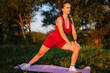© sementsova321 - A young woman stretches gracefully on a yoga mat, enjoying the calming atmosphere of a sunny evening in a peaceful park