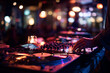 © lashkhidzetim - A DJ is playing music at a club with a crowd of people
