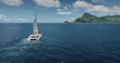 © Goinyk - Fiji, Kuata island: White catamaran with tourists sailing blue ocean water near tropical island, under bright sunny sky. Remote wild nature paradise, exotic summer travel. Aerial drone flight