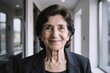© EliteLensCraftImages - Smiling mature brunette businesswoman black suit office hallway portrait