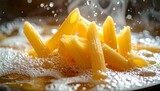 Close-up shot of penne pasta cooking in boiling water with steam rising. Water droplets and bubbles surround the yellow pasta