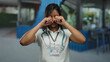 © Krakenimages.com - Hispanic female doctor smiling with stethoscope on a street terrace suggesting a mix of healthcare and urban outdoor environment.