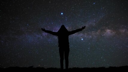 Wall Mural - Woman with arms wide open enjoying outdoors under stars, planets and Milky way.